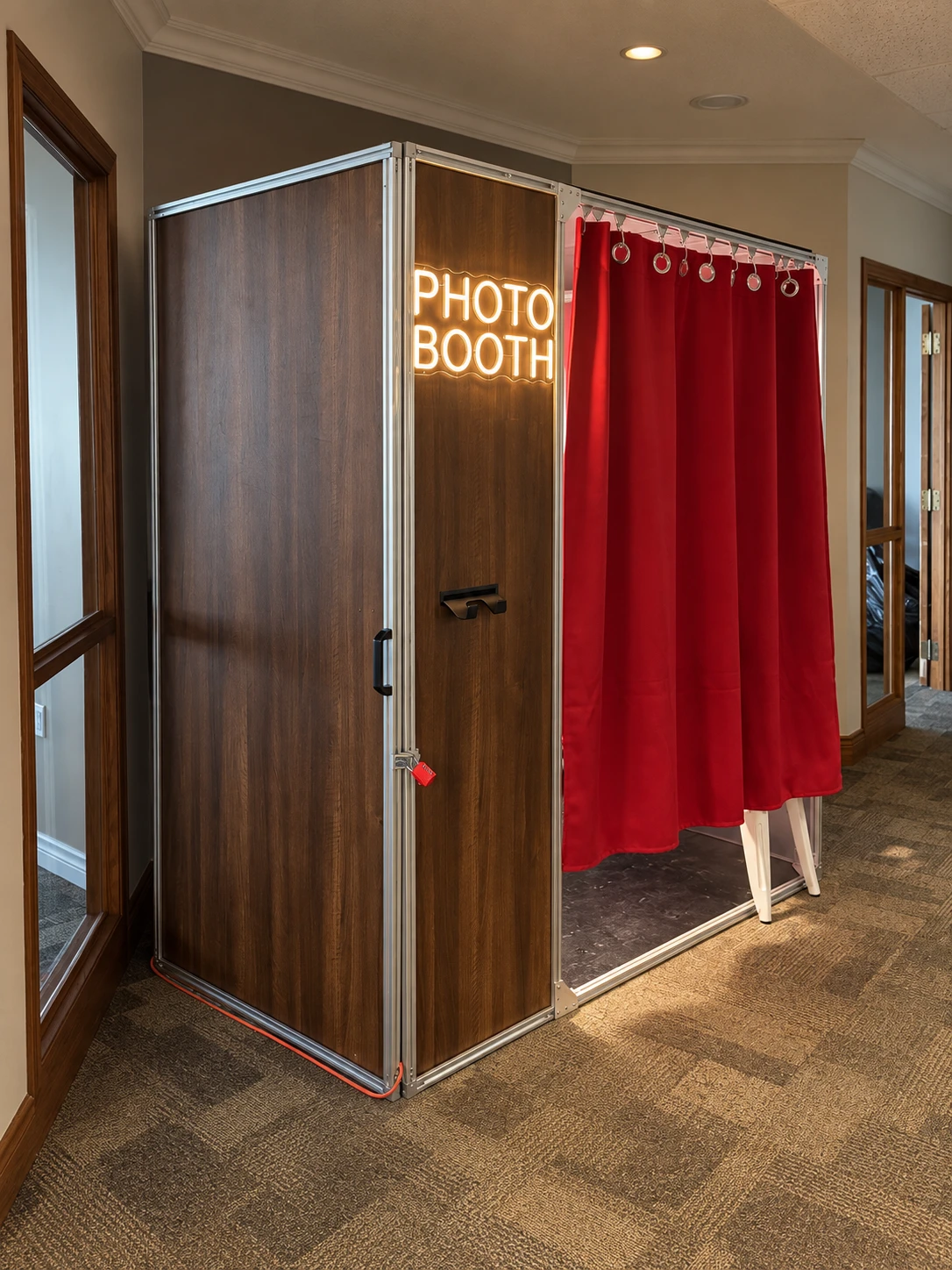 Real booth photographed at an angle, showing its enclosure and wood-grain cabinet